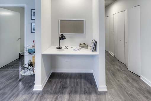 A white bathroom with a vanity and a mirror.