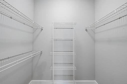 Empty white shelves in a room.