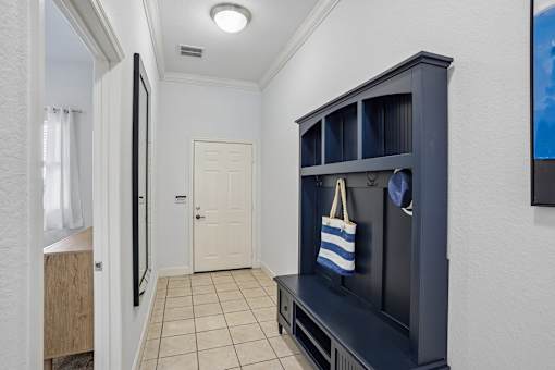 A room with a white door and a black cabinet.