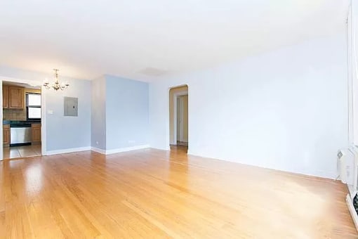 A room with wooden floors and white walls.