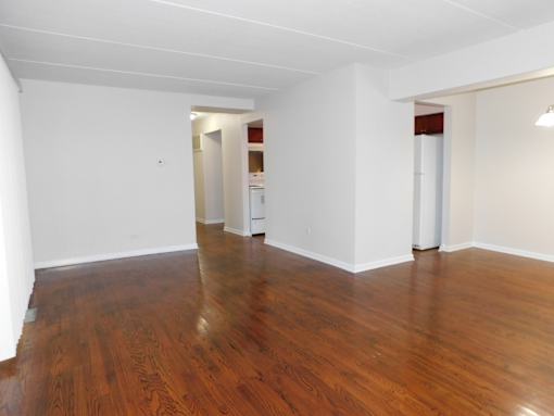 A room with wooden floors and white walls.