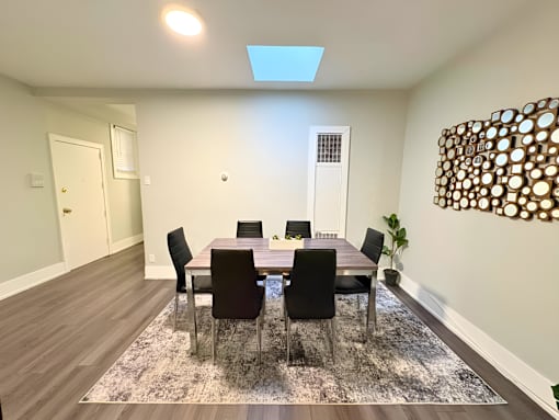 A dining room with a table set for six.
