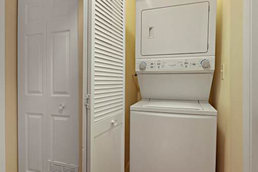 A white washing machine in a small room.