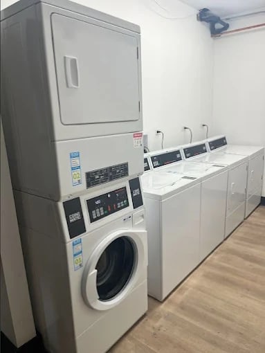 A row of washing machines in a laundromat.