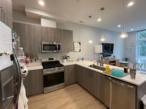 A modern kitchen with stainless steel appliances and wooden cabinets.