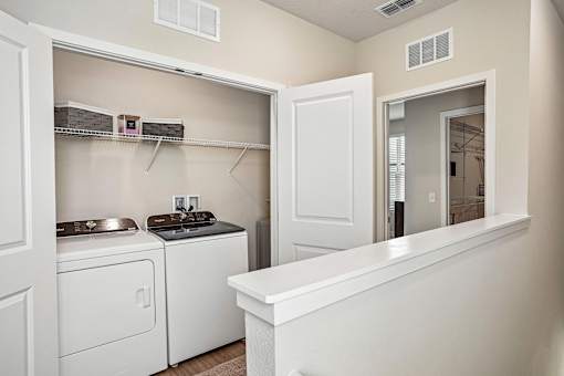 A small laundry room with a washer and dryer.