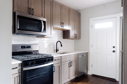 a kitchen with stainless steel appliances and wooden cabinets