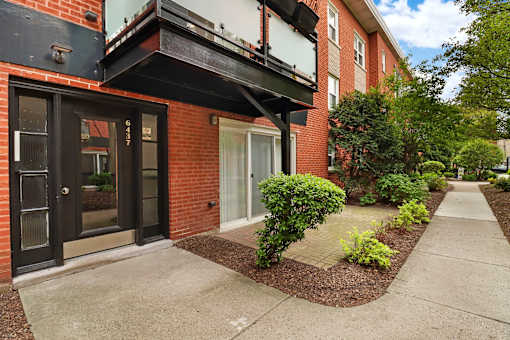 A red brick building with a black door and windows.