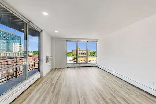 A room with a large window and a wooden floor.