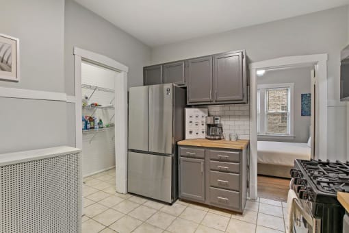 a kitchen with a refrigerator and a stove and a sink