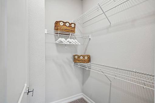 A white wall with a shelf and a cake on it.
