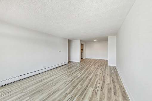 A room with wooden flooring and white walls.