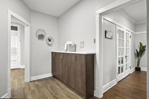 a living room with a counter and a door into a hallway