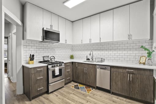 a kitchen with white cabinets and a stove and a microwave