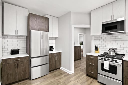 a kitchen with white appliances and wooden cabinets