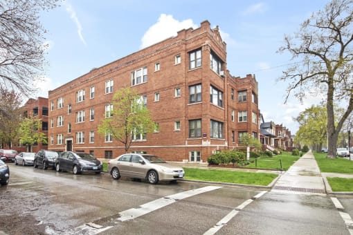 a large brick building with cars parked in front of it