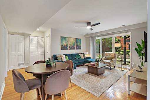 A modern living room with a dining table and chairs.