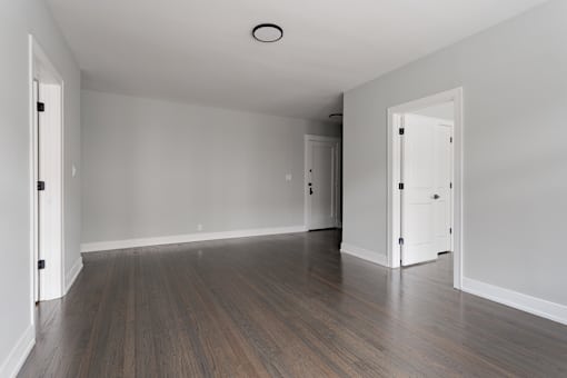 A room with wooden floors and white walls.