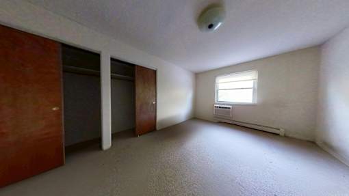 A room with a window and a door.