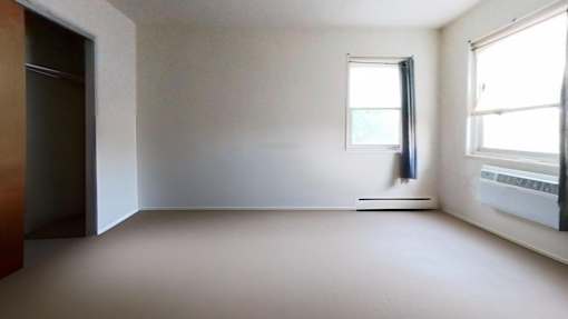 A room with a window and a door.