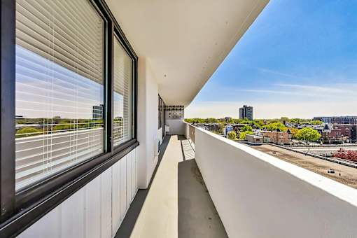 A balcony with a view of a cityscape.