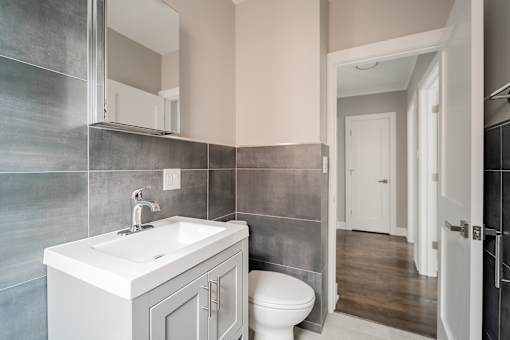 A bathroom with a white sink and toilet.