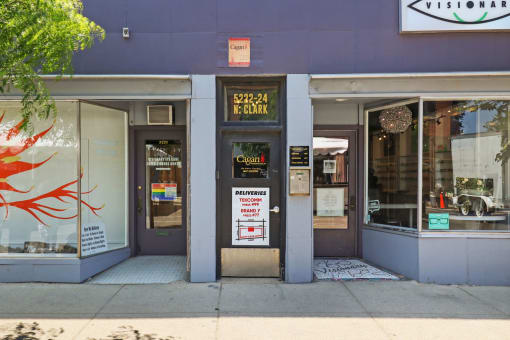 the front of a restaurant with a sign in the door