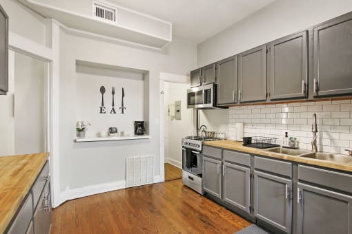 a kitchen with stainless steel appliances and a wood floor
