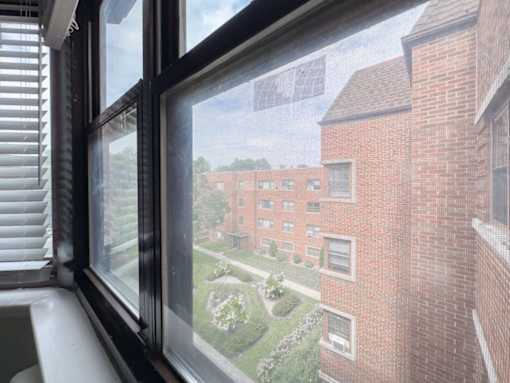 a large window with a view of a brick building