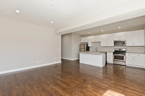 A kitchen with white cabinets and stainless steel appliances.