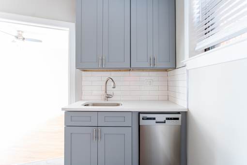 A kitchen with a sink and a dishwasher.