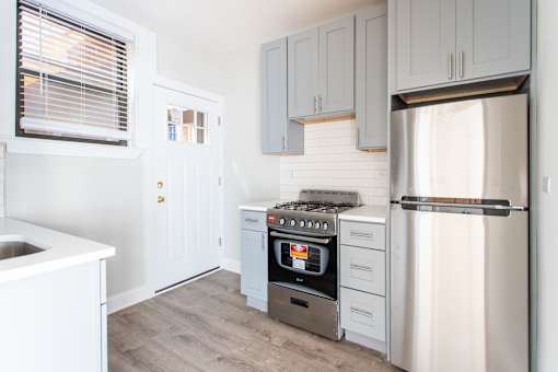 A kitchen with a stove, oven, and refrigerator.