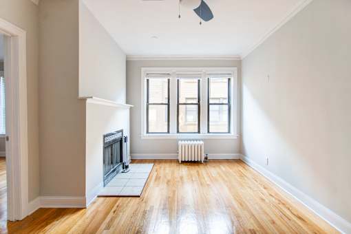 A room with a fireplace and a fan.