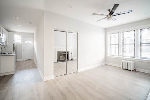 A spacious living room with a fireplace and sliding glass doors.