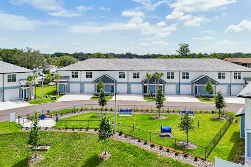 A large building complex with a playground in front.