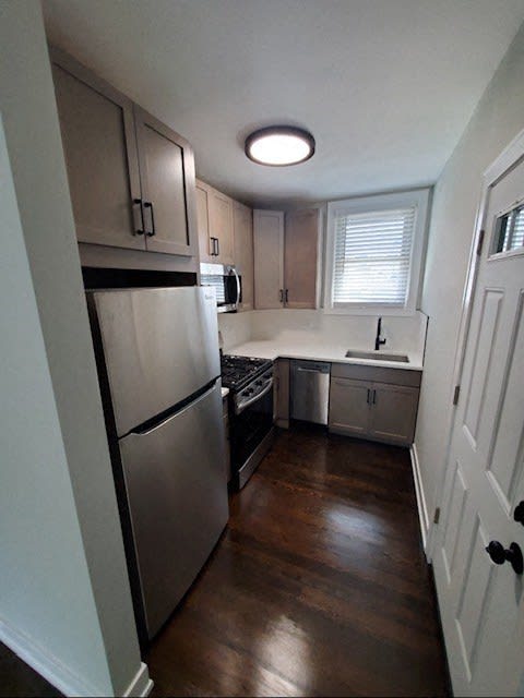 a small kitchen with a refrigerator and a sink