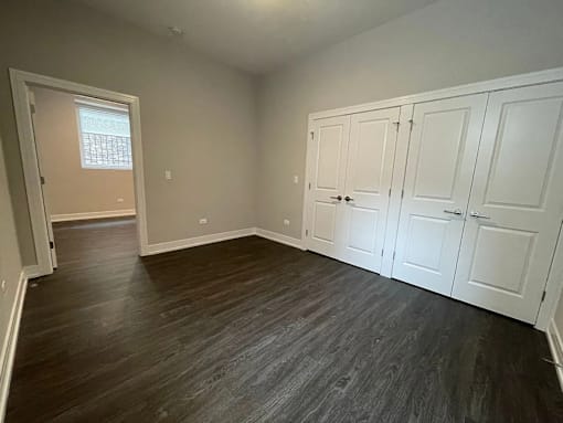 A room with white cupboards and a window.