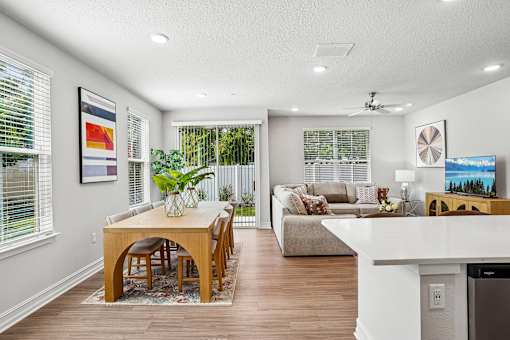 A modern dining room with a wooden table and chairs.