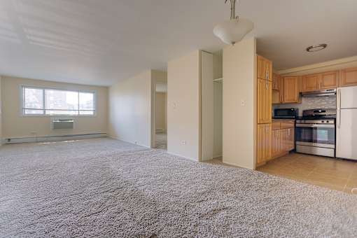 A kitchen with wooden cabinets and a white fridge.