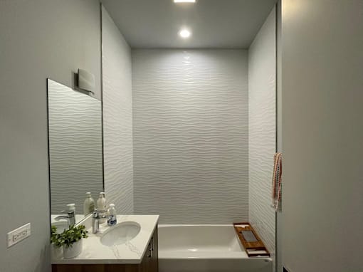 A bathroom with a white sink and a white bathtub.