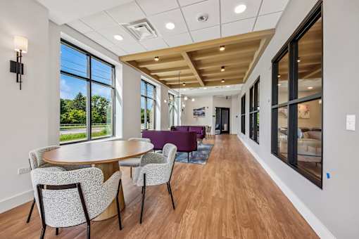 A dining room with a round table and chairs.