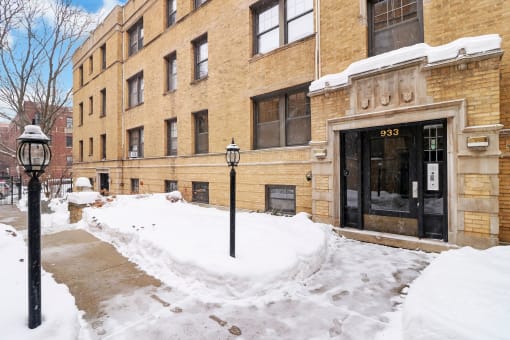 a building on a city street covered in snow
