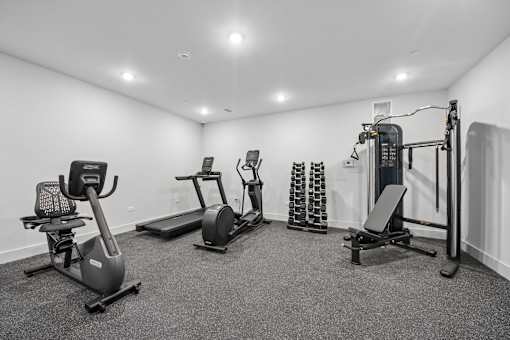 A spacious home gym with a variety of exercise equipment.