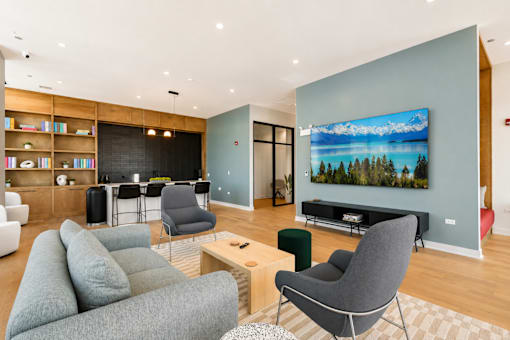 A living room with a grey couch, a chair, and a television.