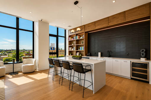 A modern kitchen with a dining table and chairs.