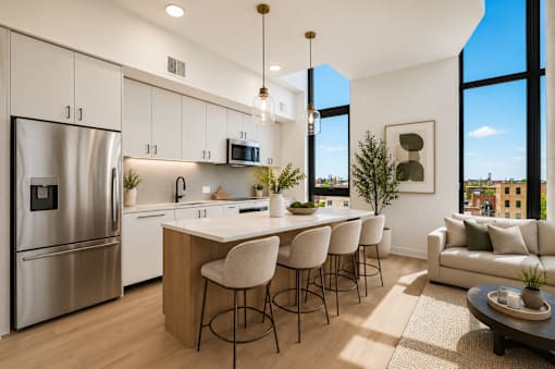 A modern kitchen with a bar area and a view of the city.