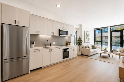 A modern kitchen with stainless steel appliances and white cabinetry.