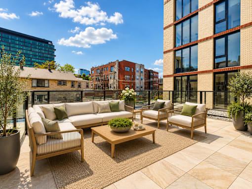A patio with a couch, chairs, and a coffee table.