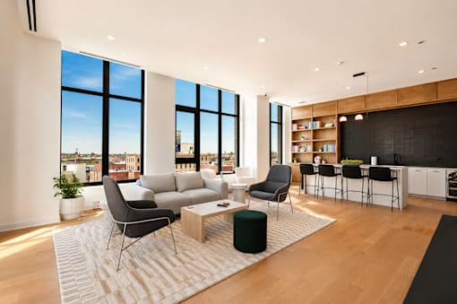 A modern living room with a large window overlooking the city.
