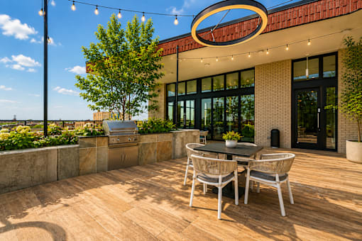 A patio with a table and chairs is set up outside a building.